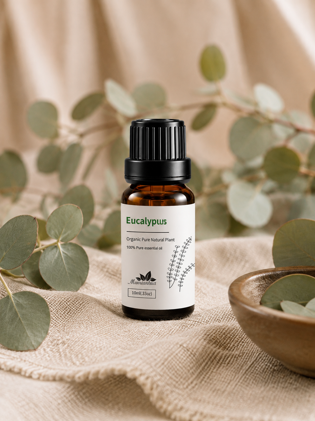 Amber Wellthious essential oil bottle framed by eucalyptus branches on soft fabric