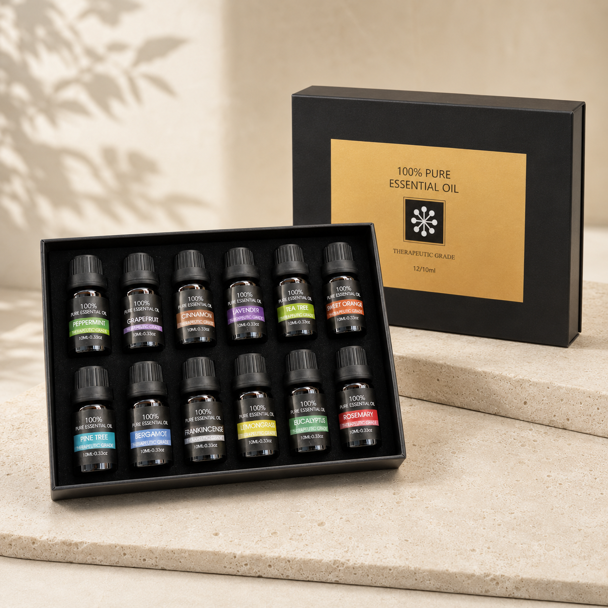 Twelve-bottle essential oil discovery set in black tray with black and gold gift box