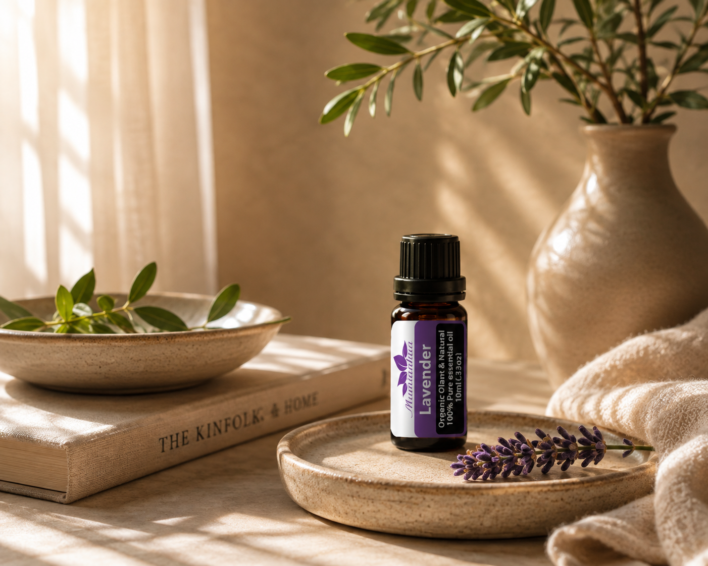Lavender essential oil bottle with purple and white packaging on a ceramic dish beside fresh lavender in soft daylight