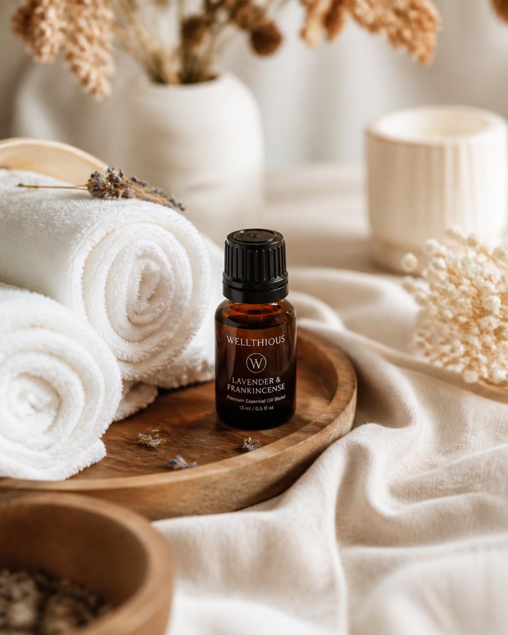 A calming spa ritual with a Wellthious amber bottle on a wooden tray beside rolled white towels